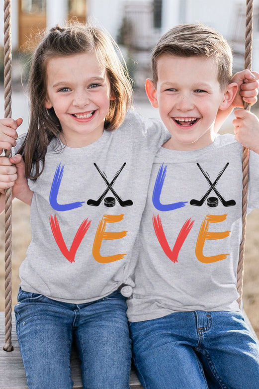 Girl and boy wearing an athletic heather Bella and Canvas 3001Y crewneck youth t-shirt. It says love in a brushed paint font. The o is replaced with two crossed hockey sticks and a hockey puck.