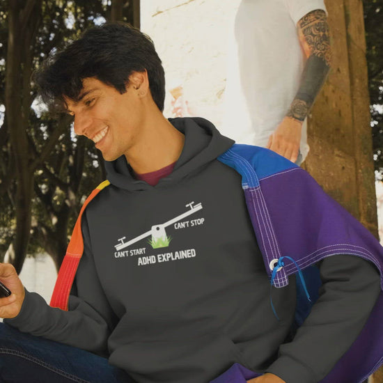 Video of two men joking with an ice cream cone. One wears a premium black hoodie that says ADHD explained can't start can't stop
