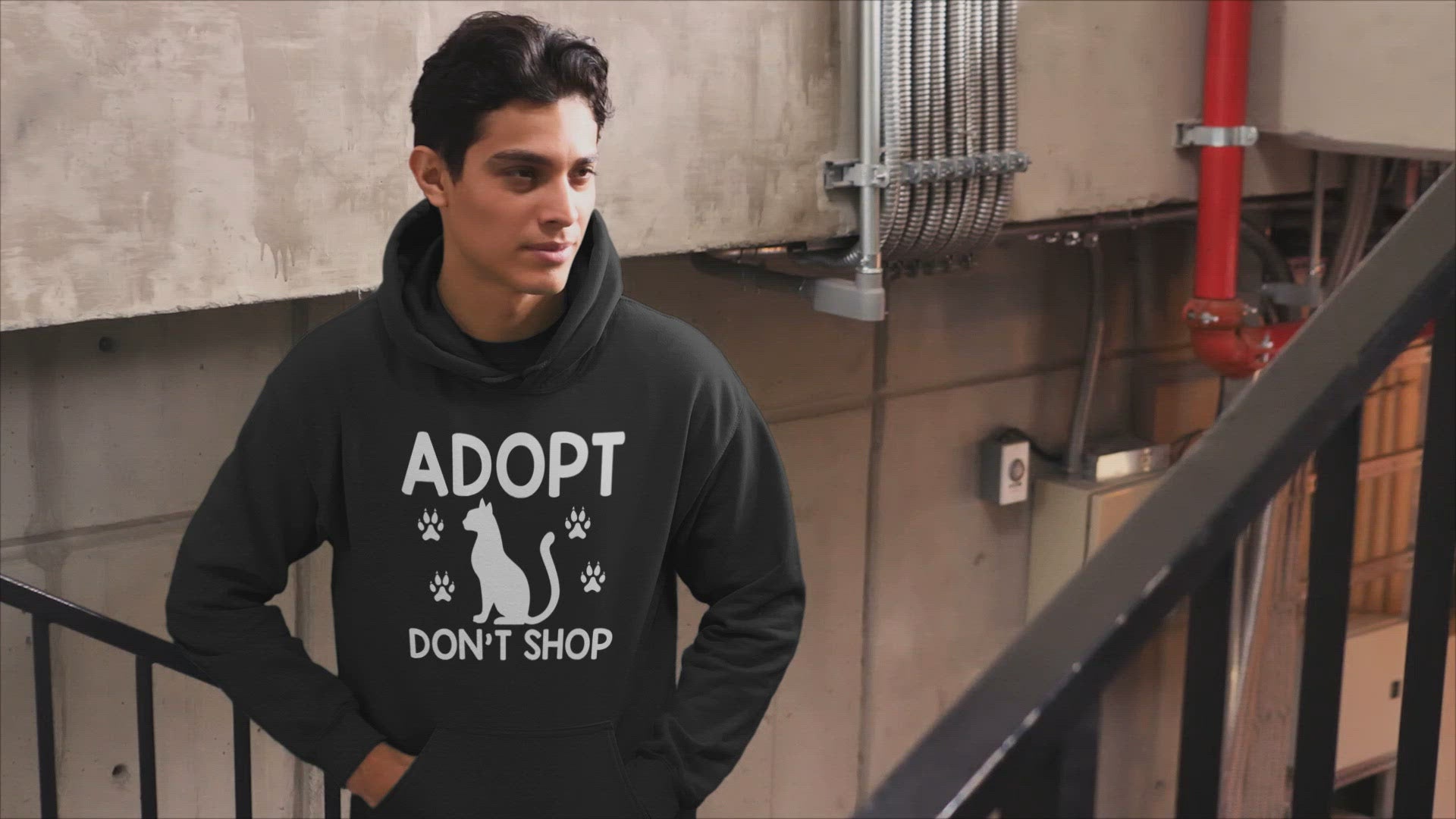 Video of a man wearing a black hoodie that says adopt don't shop