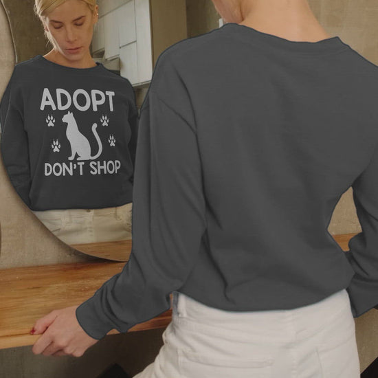 Video of a woman wearing a charcoal adopt don't shop long sleeve t-shirt