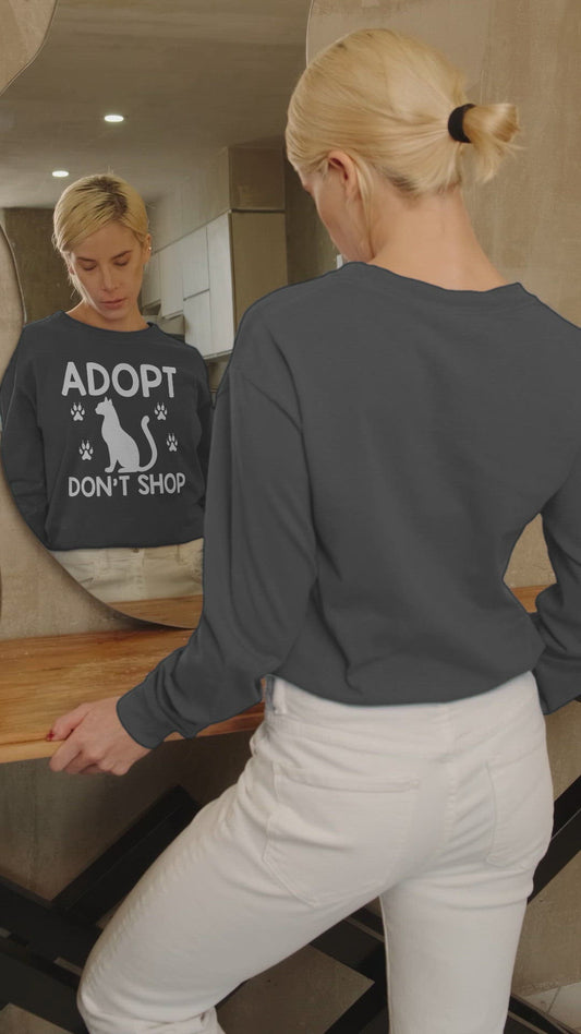 Video of a woman wearing a charcoal adopt don't shop long sleeve t-shirt